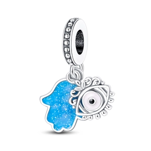 Macro detail of silver-plated Hamsa and Evil Eye charm with blue glitter enamel finish
