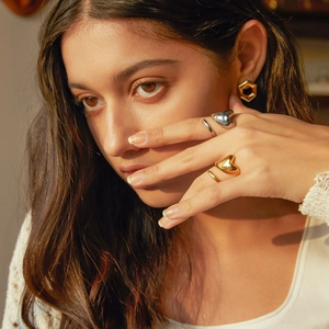 18k gold plated stainless steel intertwined heart rings and hexagon studs on model