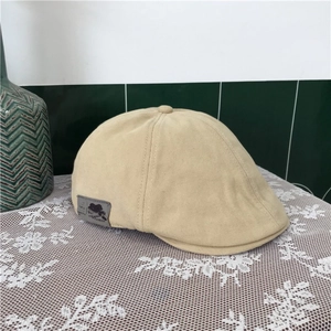 Detailed shot of the cotton duckbill beret side with fashion patch and adjustable design