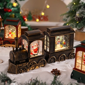 Close-up of vintage Santa train snow globe with festive warm lights and artificial snow