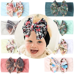 Detail view of baby bow headbands featuring various floral prints and colorful patterns