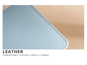Macro detail of light blue litchi grain leather with professional fine stitching work