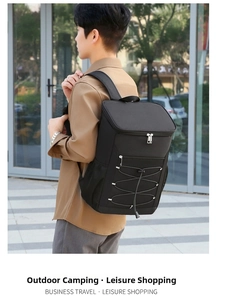 Detailed view of black insulated backpack with reflective strips and bungee cord storage