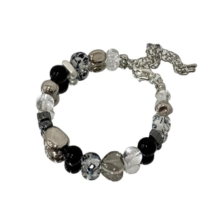 Mixed bead bracelet with silver metal balls and heart charms on a white background