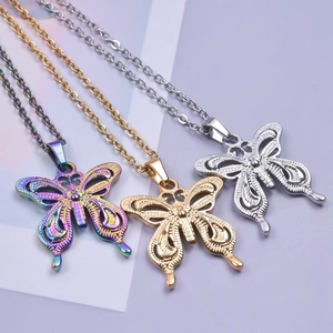 Stainless steel butterfly necklaces in rainbow gold and silver finishes on purple paper