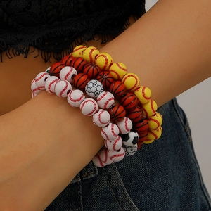 Close-up of sports themed beaded bracelets with baseball, basketball, and soccer designs