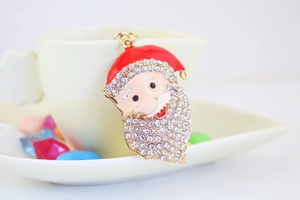 Macro shot of sparkling rhinestone-encrusted Santa Claus keychain with golden metal finish