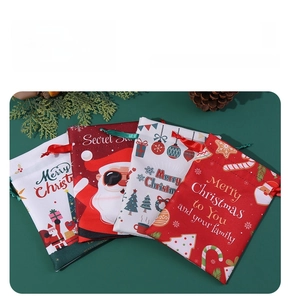 Detailed view of four polyester Christmas drawstring gift bags with festive holiday patterns