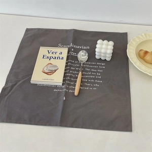 Dark grey rectangular linen placemat with white Scandinavian minimalist design text