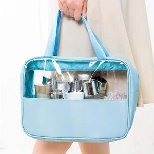 Detail of light blue semi-transparent PVC makeup bag with leather trim and handle