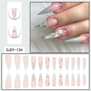 Long almond press-on nails with pink-green gradient, gold foil accents and rhinestones
