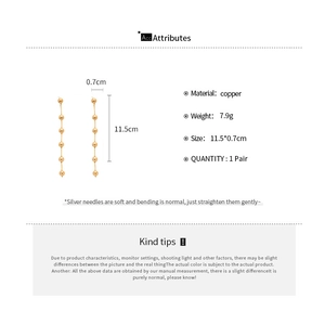 Detailed dimensions and material specs for gold beaded tassel earrings on white backdrop