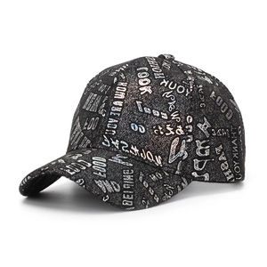 Detailed close-up of a black baseball cap featuring iridescent graffiti-style letter prints
