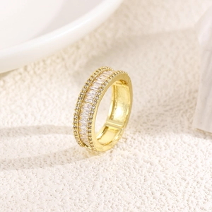 Macro detail of gold plated ring featuring baguette-cut and pavé-set cubic zirconia