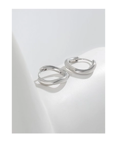 Detailed view of silver S925 sterling silver hoop earrings with irregular wave design