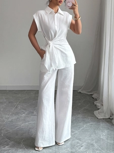 Elegant white two-piece set featuring sleeveless tie-waist shirt and wide-leg trousers