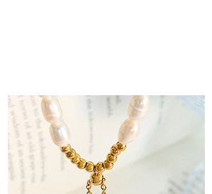 Macro shot of elegant baroque pearl necklace with polished gold bead details
