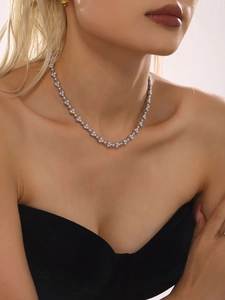 Close-up of elegant stainless steel necklace with small pearls worn by a model
