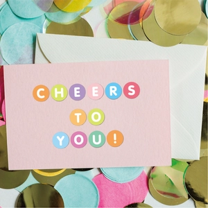 Detail of DIY card with colorful 0.5-inch dot stickers spelling Cheers to You
