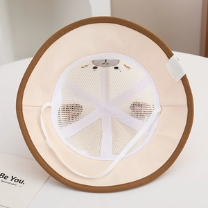 Detailed interior of a beige mesh fisherman hat for kids with soft embroidery and chin strap