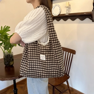 Plaid canvas shoulder tote bag with brown checkered wool texture for casual daily use
