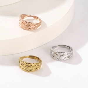 Detailed view of adjustable woven mesh rings in rose gold, gold, and silver finishes