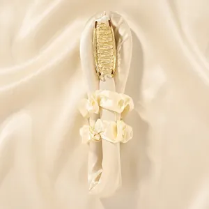 Detailed cream satin heatless hair curler set with two scrunchies and a gold metal claw clip
