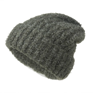 Thick dark green ear-protection knitted beanie with plush boucle yarn texture for winter