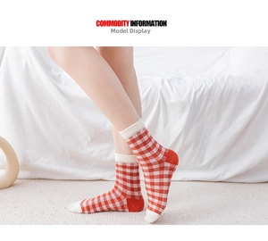 Detail of red and white checkered crew socks with contrasting off-white heels and toes