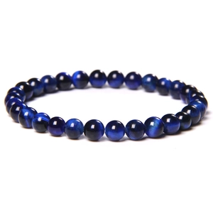 Macro shot of natural blue tiger eye stone beads with unique cat eye light effect