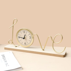 Creative gold metal 'LOVE' letter clock on wooden base for modern desktop decor