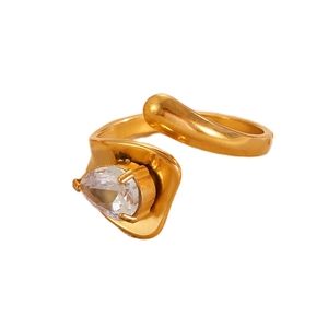 Detailed view of an irregular gold ring featuring a prong-set pear cut zircon stone