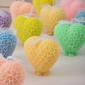 Macro detail of heart-shaped rose scented candles with delicate floral textures and ribbons