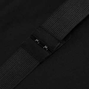 Detail of double-row metal hooks and elastic mesh band on a black strapless evening dress