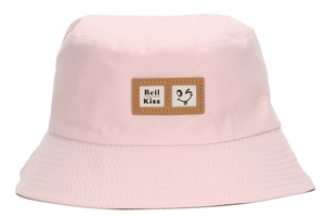 Detailed close-up of pink cotton sun hat featuring a cute winking smile patch logo