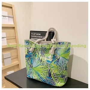 Close-up of tropical palm leaf print canvas tote with thick cotton rope handles