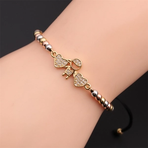 Adjustable woven bracelet with cubic zirconia girl charm and heart accents in three colors