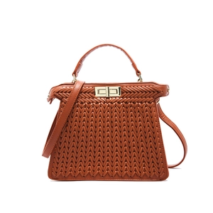Brown woven leather handbag with gold lock and top handle, elegant versatile shoulder bag
