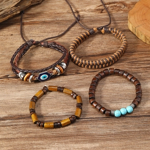 Detail of four-piece layered men's bracelet set with wooden beads and woven leather