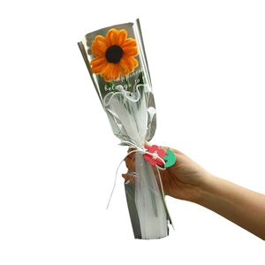 Handmade pipe cleaner sunflower bouquet in clear wrap with a ribbon and smile tag