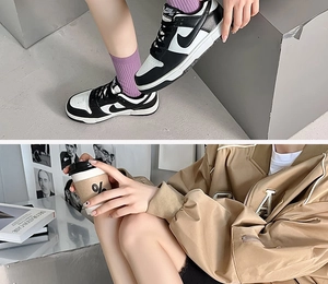 Detail of trendy color-block mid-calf socks with sports embroidery and premium casual style