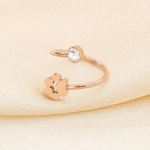 Detailed close-up of rose gold open ring with crystal inlay and hollow cat paw design