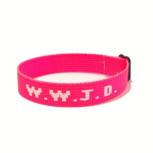 Detailed close-up of pink woven W.W.J.D. wristband with black plastic buckle closure