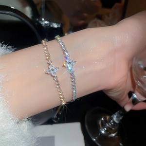Close-up of sparkling zircon clover tennis bracelets in gold and silver finish