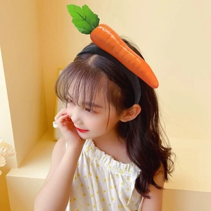 Funny giant carrot vegetable headband for women with green leaves on bright background