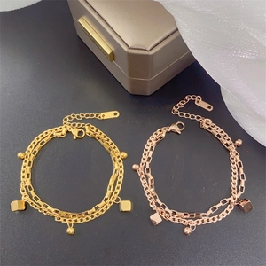 Detailed close-up of double-layer stainless steel bracelet with square beads and golden finish