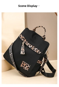 Detail view of leopard print trim on black Oxford backpack with stylish tassel charm