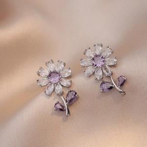 Elegant floral stud earrings with purple crystals and white zircon petals on silk