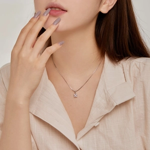 Close-up of minimalist S925 sterling silver necklace with square cubic zirconia pendant
