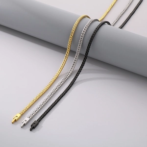 Detailed view of woven dragon bone chains in gold, silver, and black with rectangular clasps